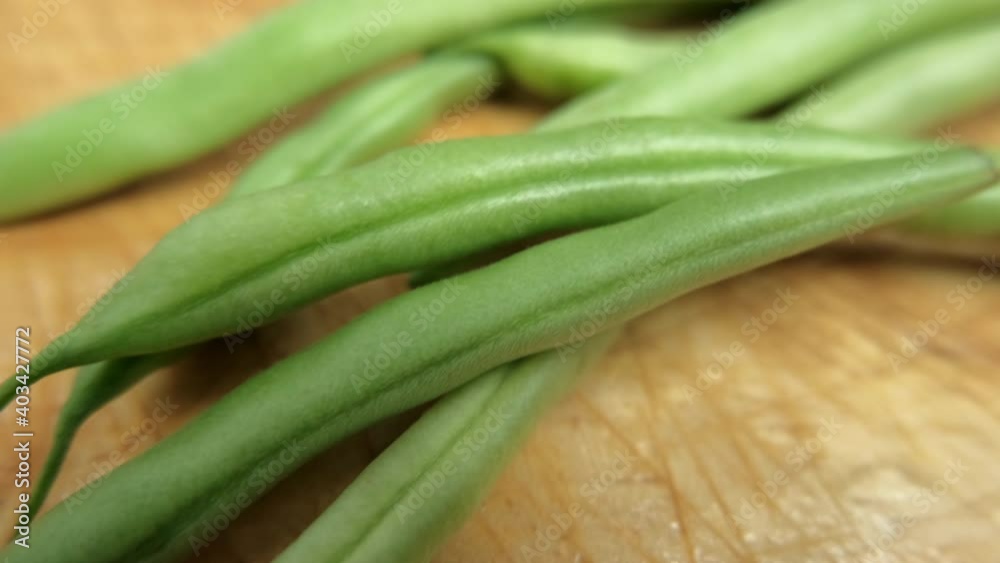 Green beans isolated on a scratched wooden table