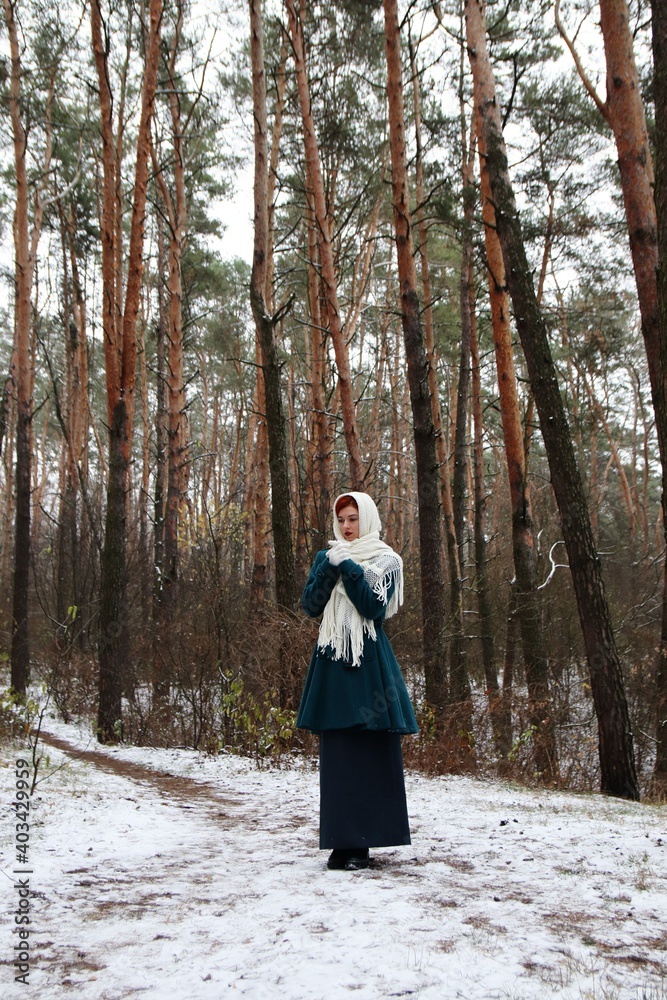 beautiful girl walking in the forest in winter