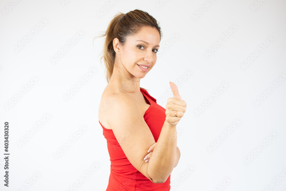 Young happy cheerful woman showing thumb up smiling over white background Young happy cheerful woman showing thumb up smiling over white background