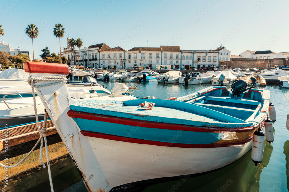 Old town of Faro with traditional wooden boat moored in marina, Portugal