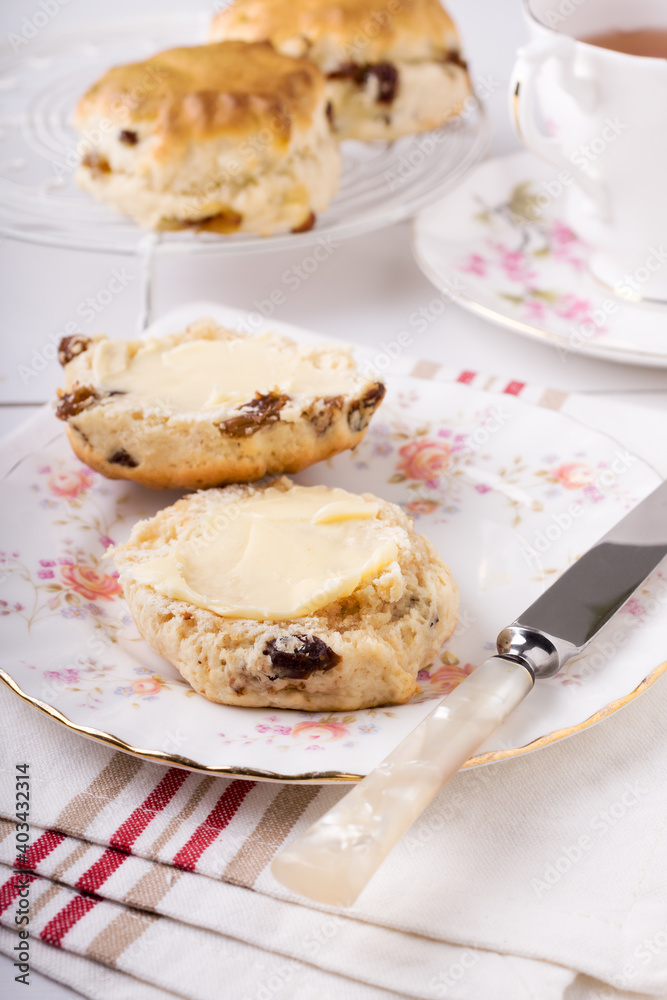 Scones a classic British cake filled with sultanas and raisins and often served buttered during afternoon tea