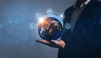 Night earth in the hands of man with icons energy sources for renewable. Eco development. Energy savings concept. Elements of this image furnished by Nasa.
