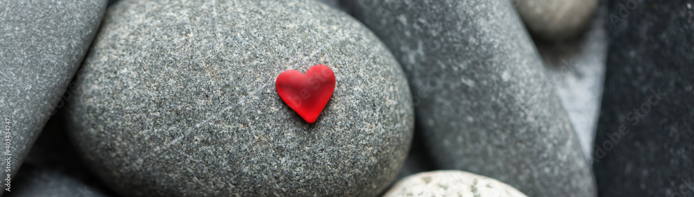 Fototapeta premium Red heart on stones. Valentines Day background
