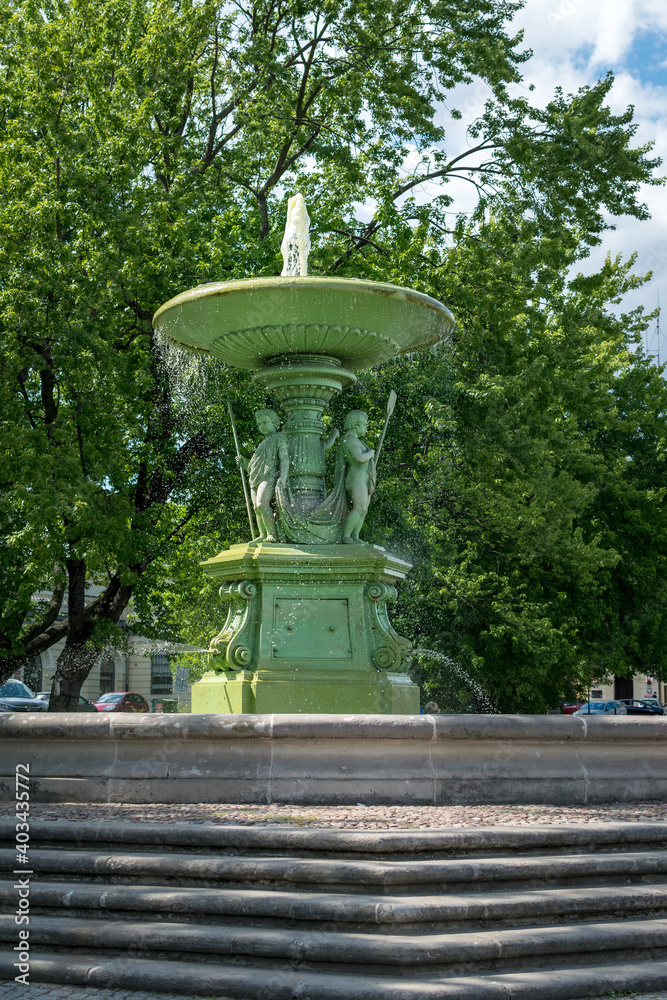 Warsaw, Poland - June 15, 2018: Fountain near Bankowy Square. A sunny day in the Polish capital. The oldest fountain in Warsaw.