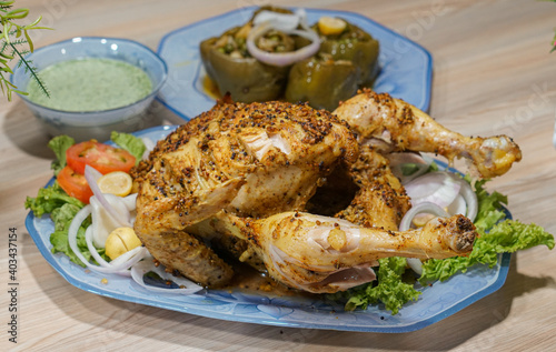 Pakistani cooked roast chicken with spicy green chatni sajji