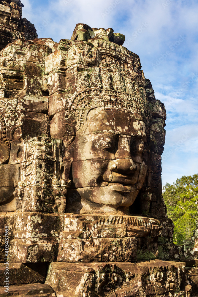Face tower in the Bayon temple in Angkor. Cambodia. Vertical view.