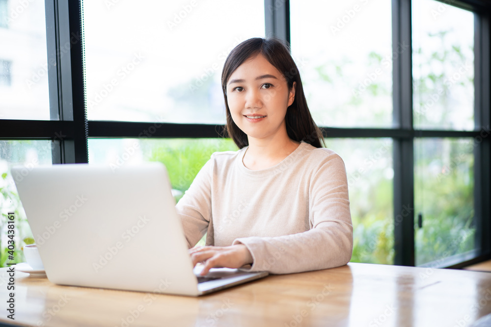 Asian beautiful working woman doing her work and drink in the coffee shop. Asian beautiful working woman doing her work and drink in the coffee shop.