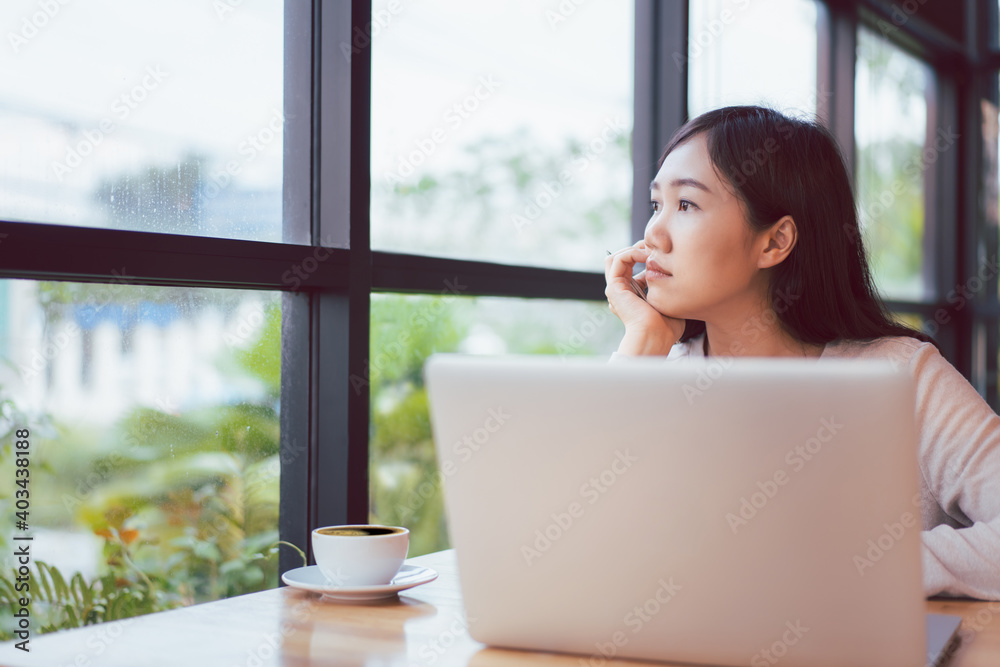 Asian beautiful working woman doing her work and drink in the coffee shop. Asian beautiful working woman doing her work and drink in the coffee shop.