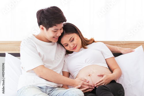 Happy Asian family and pregnancy woman
