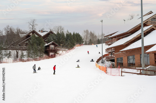 Kazan, Russia - january 3, 2021: Sviyazhsky Hills resort near Kazan. Panorama of ski resort, slope, people on the ski lift, skiers on the piste among white snow