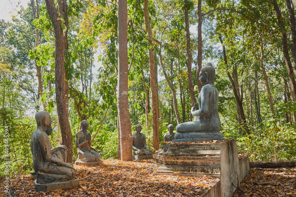 Phayao, Thailand - Nov 29, 2020: Buddha Statue Giving The First Sermon with 5 Disciples of The Buddha on Forest Background in Wat Analayo Thai Temple Phayao, Thailand - Nov 29, 2020: Buddha Statue Giving The First Sermon with 5 Disciples of The Buddha on Forest Background in Wat Analayo Thai Temple