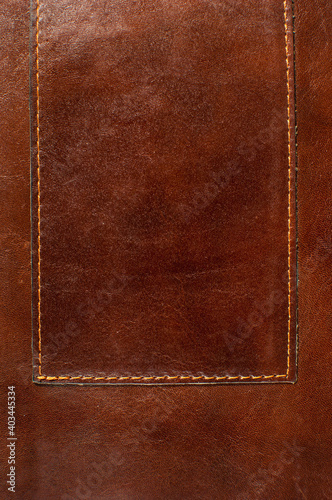Dark brown leather texture with seam