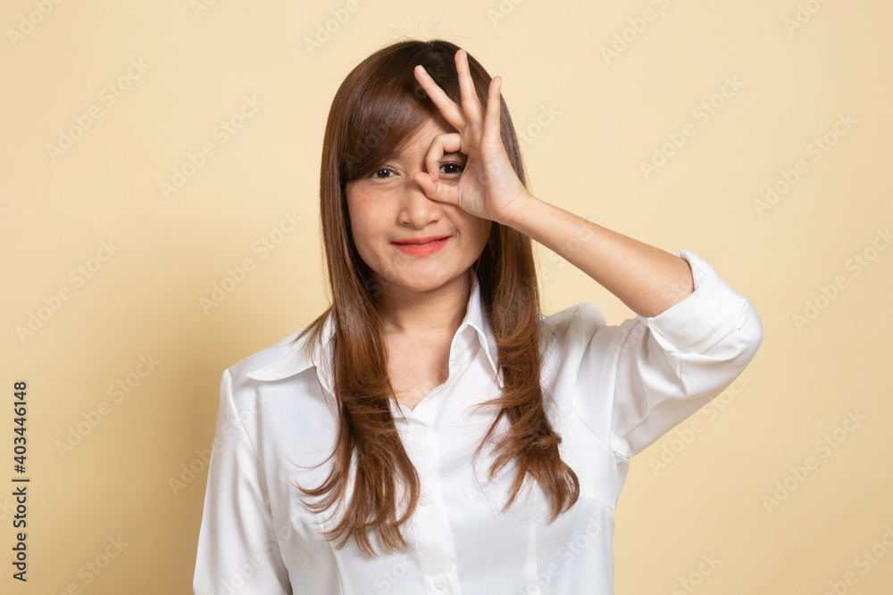 Beautiful young Asian woman show OK sign over her eye. Beautiful young Asian woman show OK sign over her eye.
