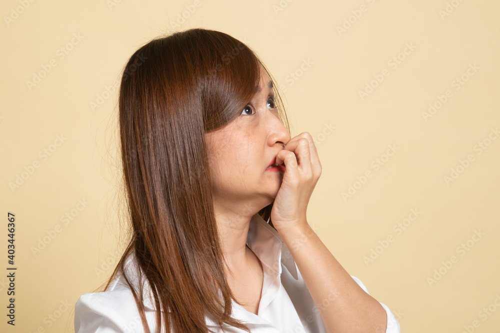 Unsure hesitant nervous young asian woman biting her fingernails. Unsure hesitant nervous young asian woman biting her fingernails.