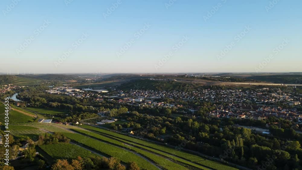 Aerial view on a small european town. Würzburg, Germany. Rooftops, vineyards and endless green fields. Filming from the air with a drone in 4K. Cinematic view. Aerial view on a small european town. Würzburg, Germany. Rooftops, vineyards and endless green fields. Filming from the air with a drone in 4K. Cinematic view.