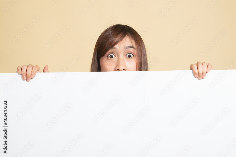 Close up of young Asian woman behind a blank sign. Close up of young Asian woman behind a blank sign.