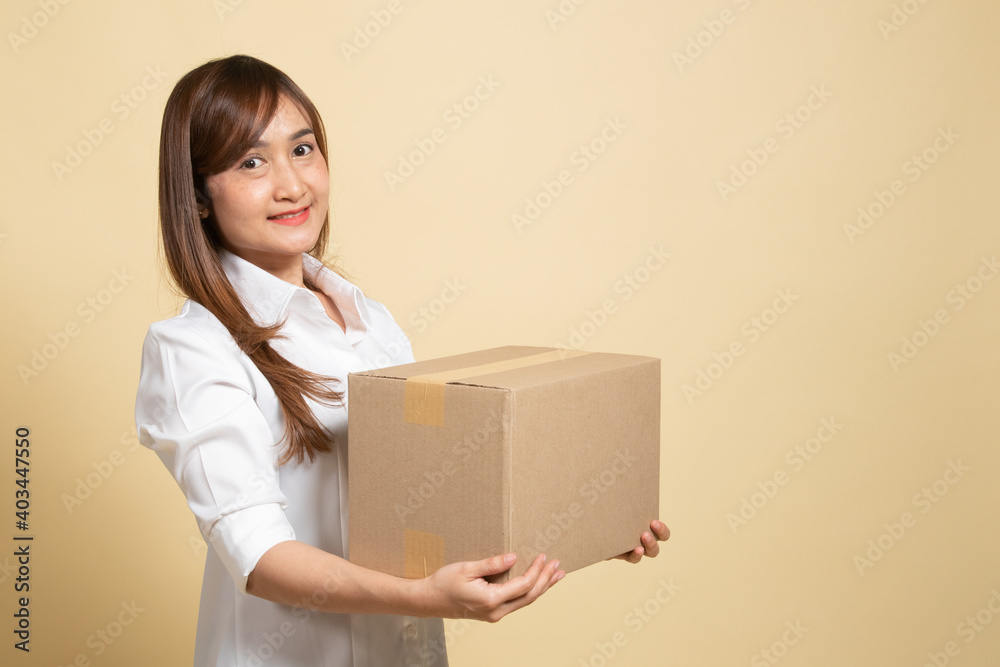 Delivery, relocation and unpacking.  young asian woman holding cardboard box.