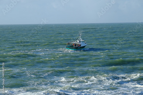 A small fishing boat on the Atlantic ocean in the west of France during the month of december 2020.
