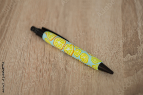 ballpoint pen covered with polymer clay lemon and orange pattern