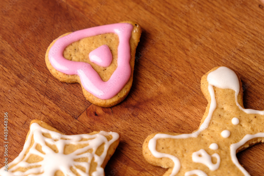 A gingerbread man and heart cookies on the wooden background. A gingerbread man and heart cookies on the wooden background.