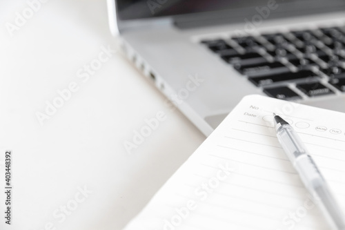 close up laptop and notebook on a desk with space for copy text.