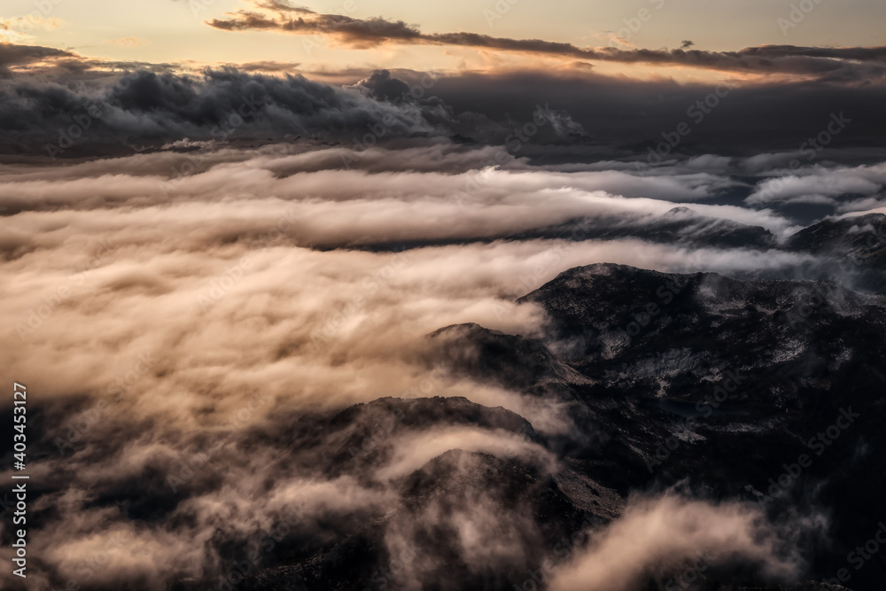 Aerial view of the rugged Canadian landscape of the mountain peaks. Taken near Chilliwack, East of Vancouver, British Columbia, Canada. Dramatic Sunset Sky Art Render
