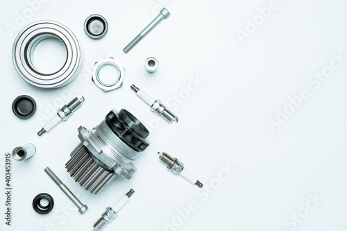 Spare parts. Auto motor mechanic spare or automotive piece on white background. Set of new metal car part. Flat lay, top view, copy space.