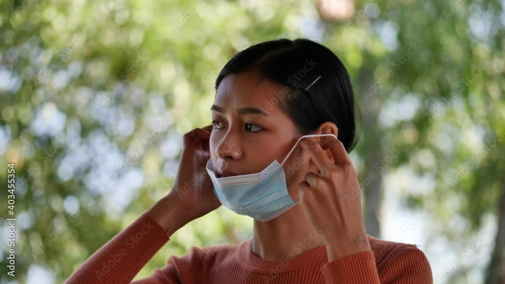 Young Asian woman wearing protective mask safe from N1H1 coronavirus protection. Young Asian woman wearing protective mask safe from N1H1 coronavirus protection.