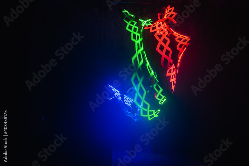 Laser show performance, dancers in suits with colored LED lamp. Very beautiful night club party.