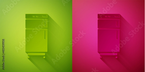 Paper cut Refrigerator icon isolated on green and pink background. Fridge freezer refrigerator. Household tech and appliances. Paper art style. Vector.
