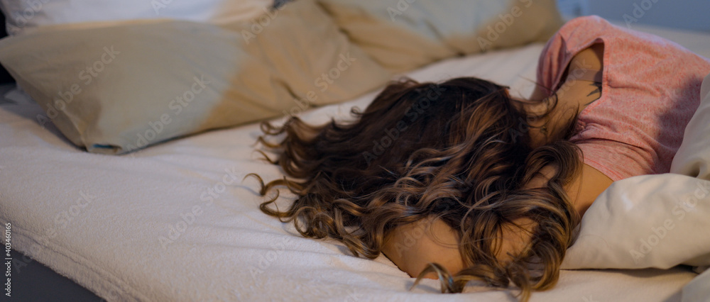 Young pretty woman lies lazy on her bed - home shooting Young pretty woman lies lazy on her bed - home shooting