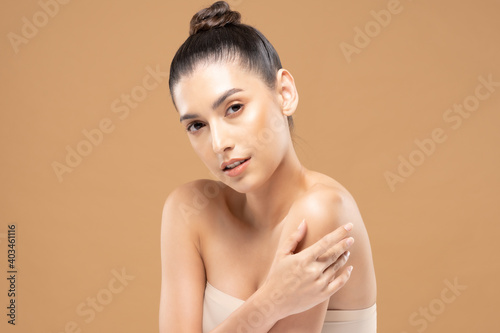 Beautiful Glamour woman touch shoulder smile with clean and fresh skin Happiness and cheerful with positive emotional,isolated on Beige background,Beauty Cosmetics and spa Facial treatment Concept