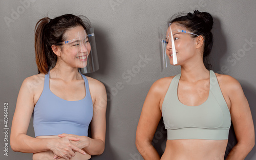 Two Asian women wearing face shield to protect virus
