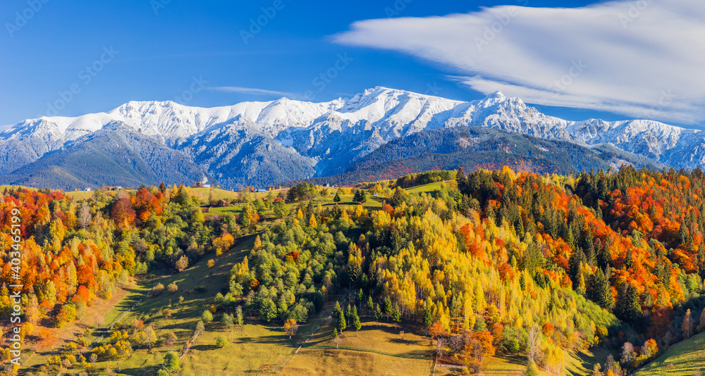 Autumn in Moeciu Village. Panorama of the rural landscape in the Carpathians, Romania.