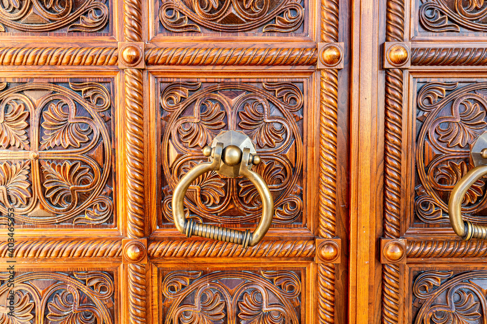 Wooden door with door knob made of bronze