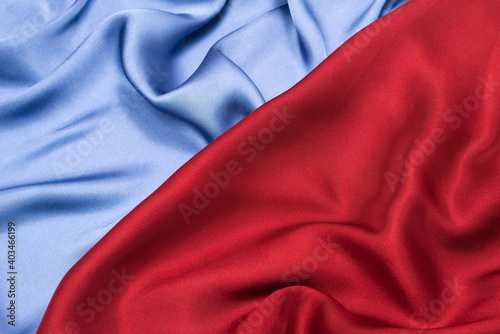 Red and blue silk or satin luxury fabric texture. Top view.