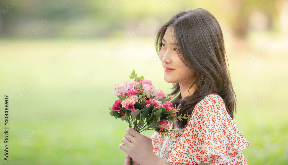 Young beautiful Asian woman enjoying her time on picnic blanket in beautiful natural park Young beautiful Asian woman enjoying her time on picnic blanket in beautiful natural park
