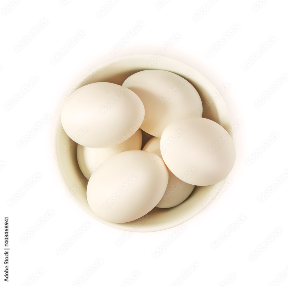 Isolated white fresh eggs in a white bowl on a white background. Organic natural healthy products. Preparing for Easter. Protein diet. Food photo, top view