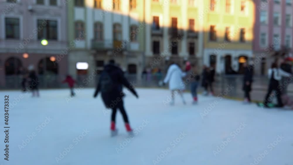 People skate on a winter rink. Out of focus. People skate on a winter rink. Out of focus.