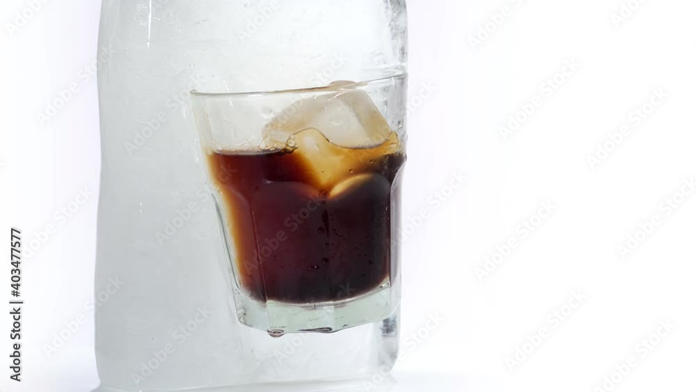 Frozen White Russian Cocktail Glass in a Ice Cube - Isolated on white Background Frozen White Russian Cocktail Glass in a Ice Cube - Isolated on white Background