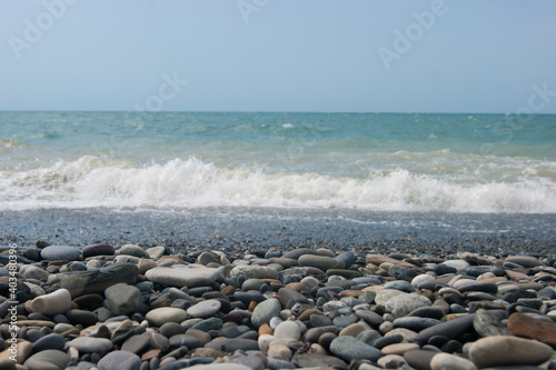 A small storm three or four points at sea, the wave hits the shore with a large pebble. Black Sea, summer vacation vacation beach travel