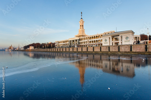 River station North in winter. Reflections of river terminal buildings on the fresh ice of the Moscow river at sunset.  Northern pier is a starting point of river cruises. Moscow, Russia