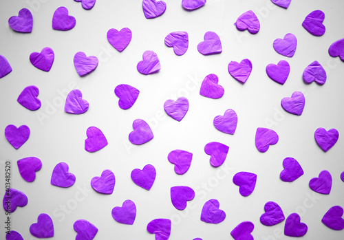 bright purple hearts confetti on white background photo