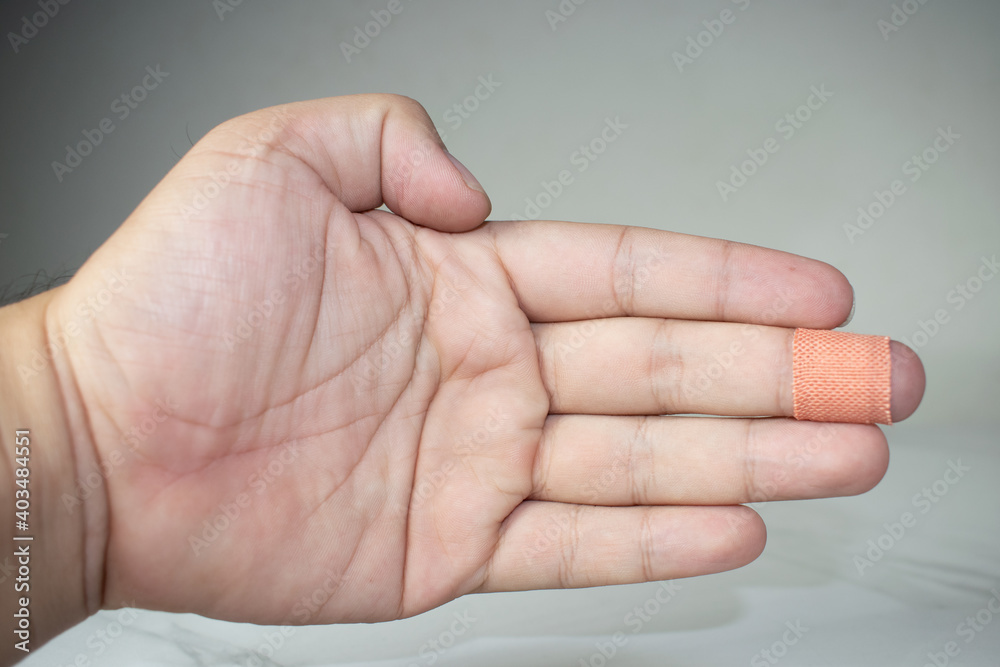 Close up of injured finger with finger plaster adhesive-image