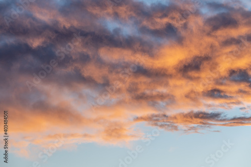 Blue sky day with colourful, colorful, coloured, pink, orange tones and hues clouds in frame. Beautiful background, sky, skies shot.  © Scalia Media