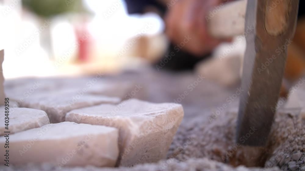 paver working on traditional portuguese cobblestone pavement slow motion paver working on traditional portuguese cobblestone pavement slow motion