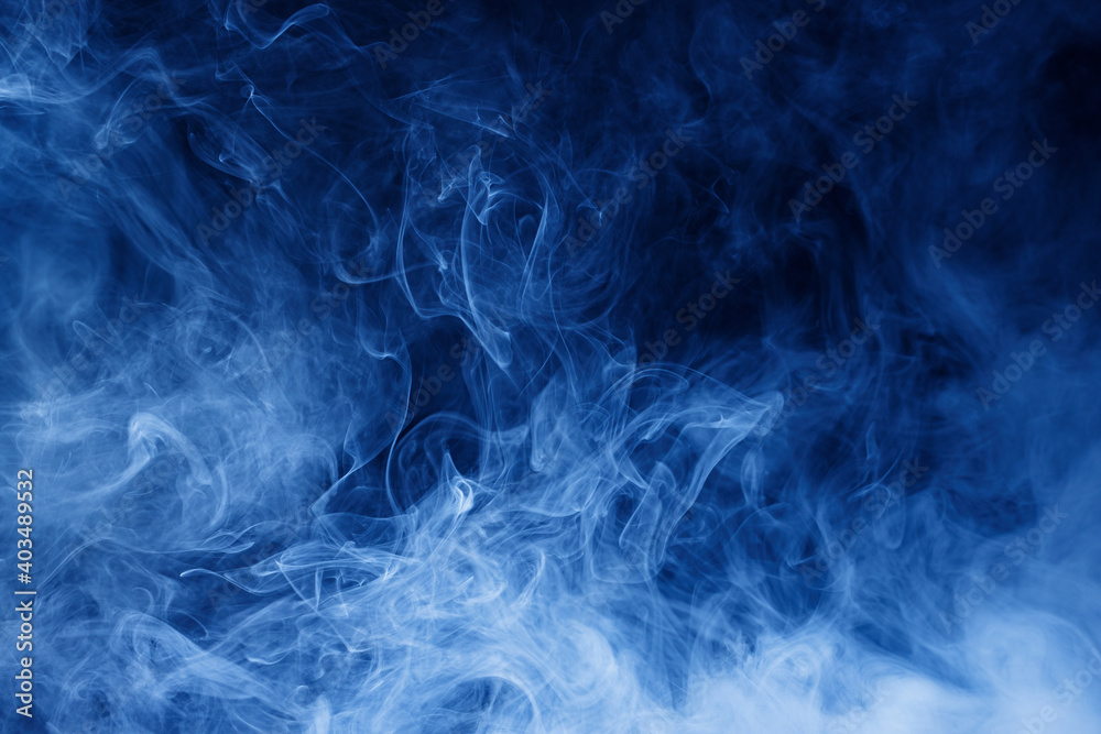 Obraz premium Abstract blue smoke moves on black background. Swirling smoke.