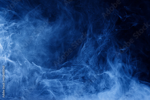Abstract blue smoke moves on black background. Swirling smoke.
