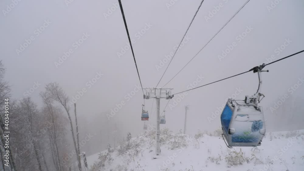 View from cable car gondola moving through heavy snowfall. View from cable car gondola moving through heavy snowfall.