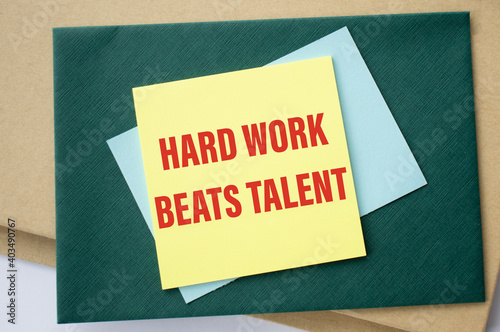 Hard Work Beats Talent written on color sticky notes over white background